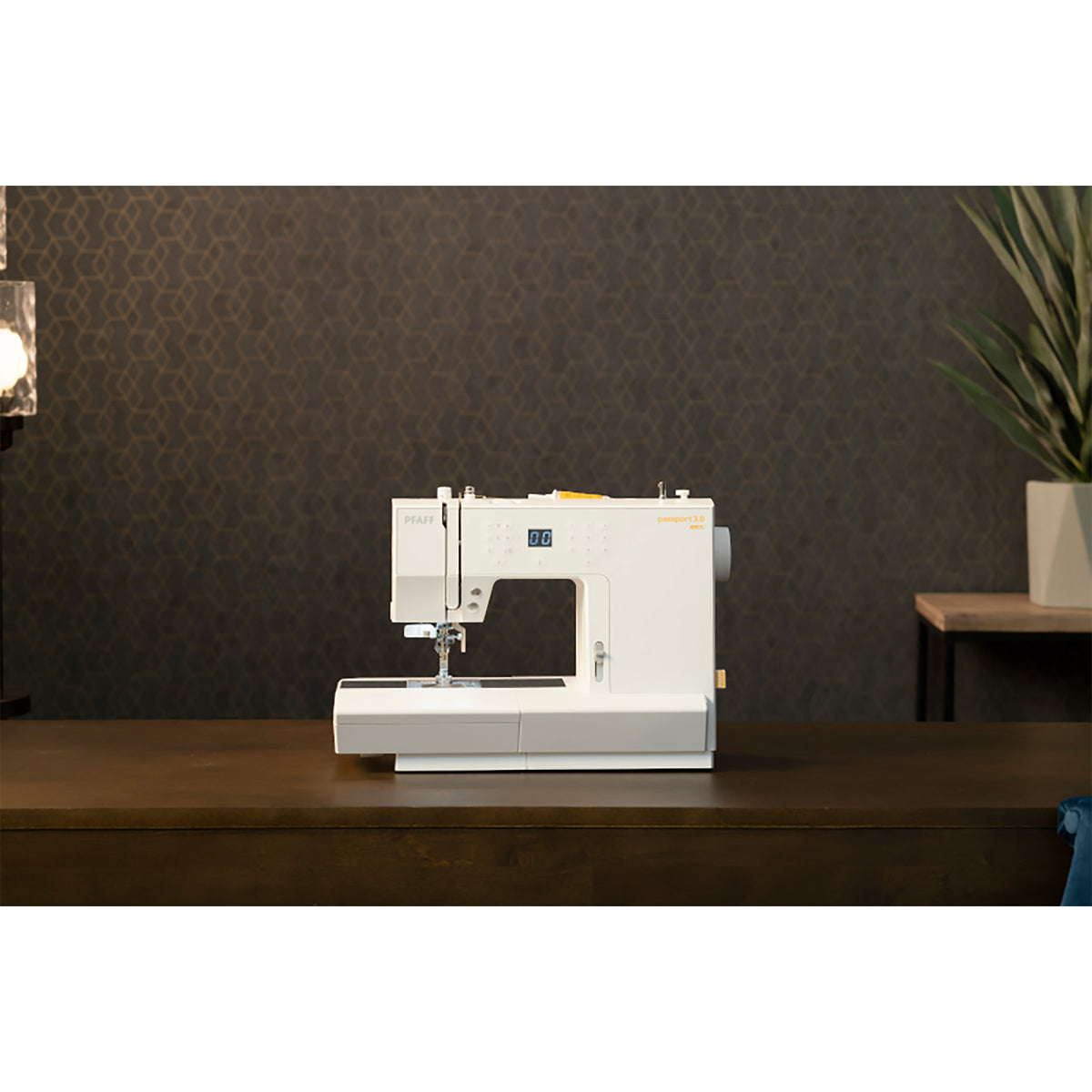 PFAFF passport 3.0 compact sewing machine on a sewing table