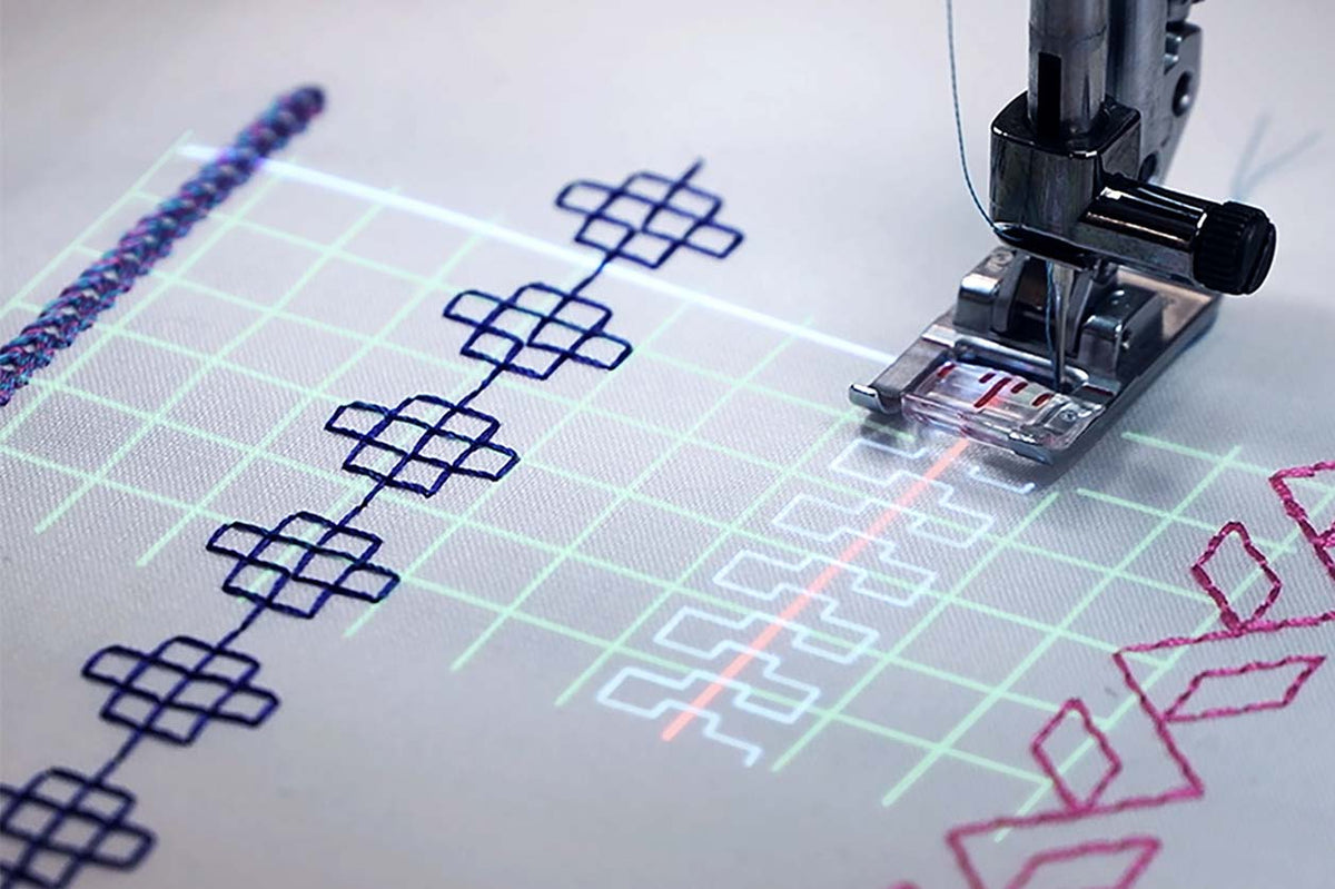 Built-in projector displaying stitch guidance on fabric beneath the PFAFF creative icon 2